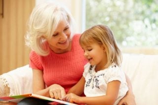 older woman reading to young girl