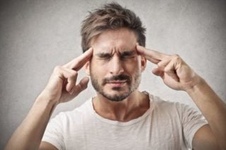 man with eyes closed, concentrating
