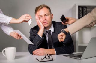 man overwhelmed by work
