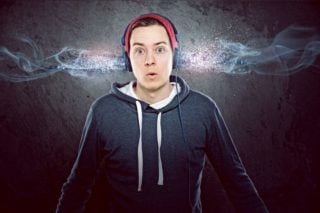 photo depicting man with headphones on acting surprised