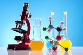 laboratory equipment - microscope, beakers, molecule models