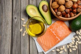 salmon, avocado, nuts, olive oil on a table