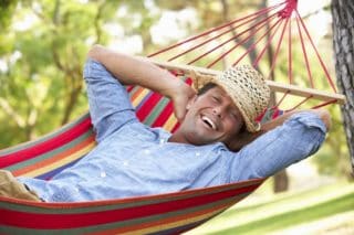 man relaxing in a hammock