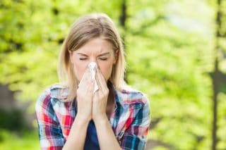 woman blowing her nose