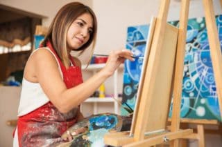 woman painting at easel