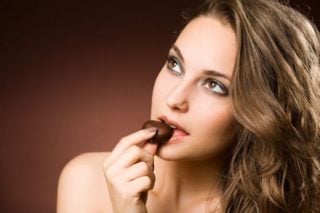 woman eating dark chocolate