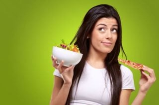 woman choosing between healthy and unhealthy foods