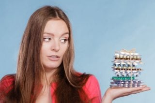 woman holding a stack of supplements