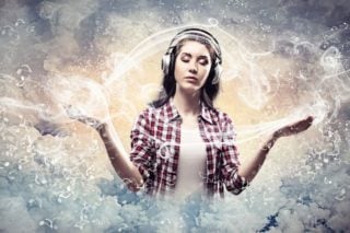 woman wearing headphones meditating