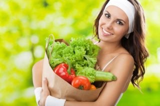 woman carrying bag of vegetables