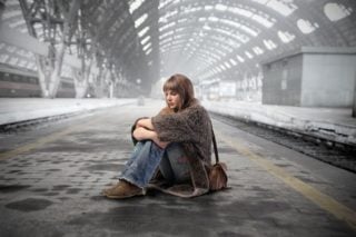 woman sitting on a train station platform