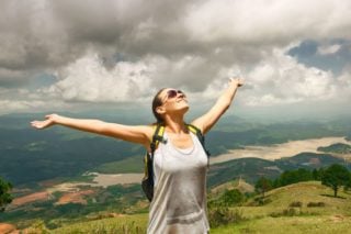 woman outdoors with arms outstretched
