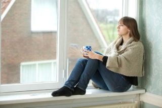 woman looking out a window
