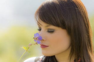 woman smelling flower