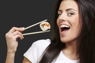 woman eating sushi