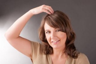 photo of a woman tapping her head